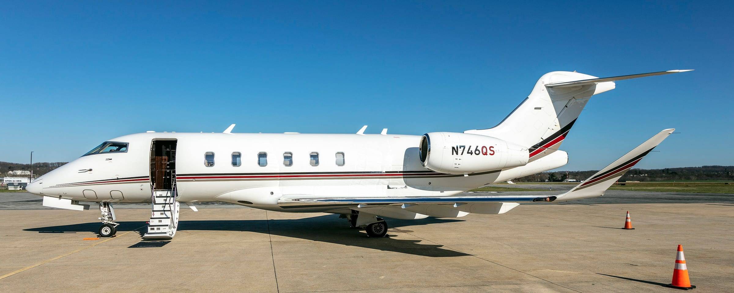 A Bombardier Challenger 300 parked on the ramp with its airstairs lowered